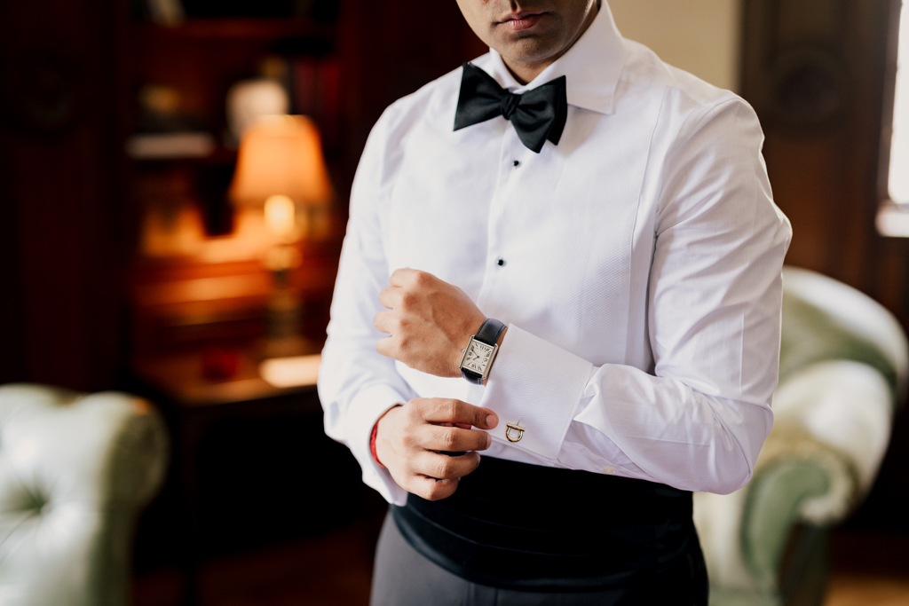 Groom's accessories including boutonniere, cufflinks, and watch at a Pleasantdale Chateau wedding in NJ.